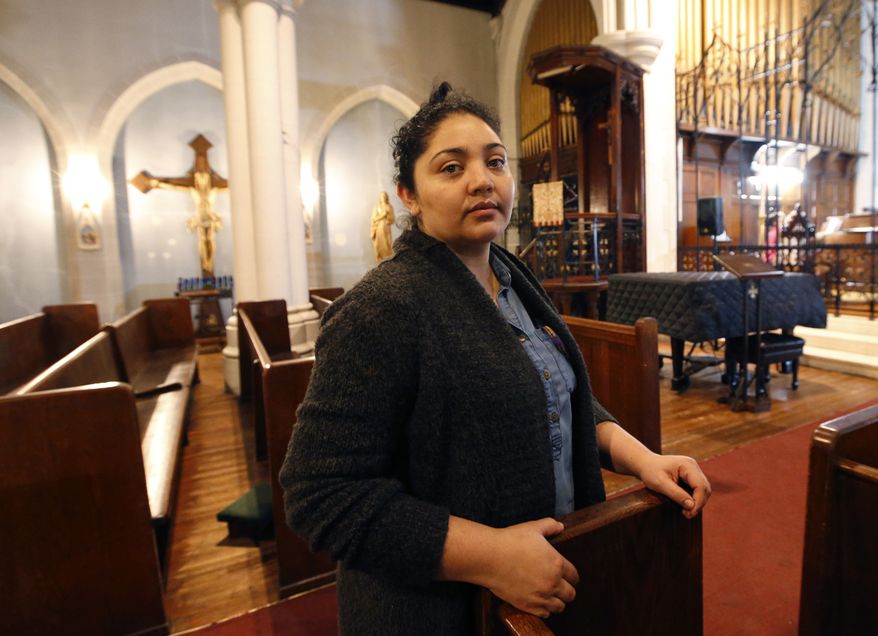In this Oct. 26, 2017, photo, Amanda Morales poses for a photograph in the sanctuary of the Holyrood Episcopal Church, the Bronx borough of New York. Morales has been living in the gothic church at the northern edge of Manhattan since August, shortly after immigration authorities ordered her deported to her homeland of Guatemala. (AP Photo/Kathy Willens) ** FILE **