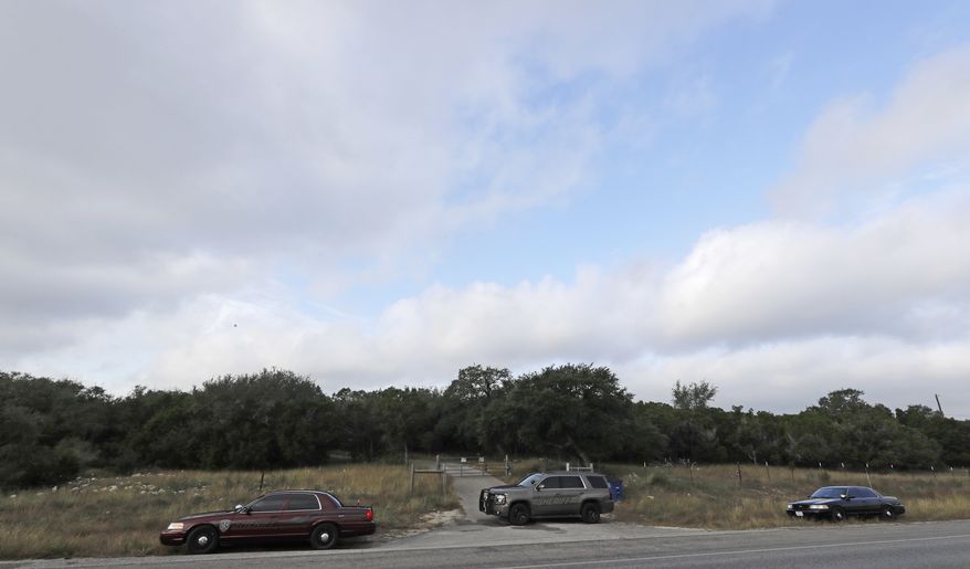 Law enforcement vehicles sit outside the entrance where Devin Patrick Kelley lived Monday, Nov. 6, 2017, in New Braunfels, Texas. Texas officials confirmed Kelley as the shooter who killed more than 20 people and wounded others at a church in Sutherland Spring, Texas, Sunday.(AP Photo/David J. Phillip)