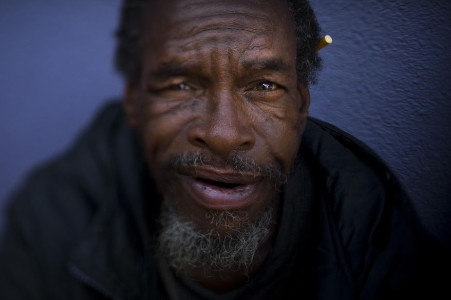 Moi Williams, 59, poses for a photo Wednesday, Sept. 13, 2017, in Los Angeles. Williams, who has been homeless for four years, said he is comfortable sleeping on the street. "I'm not bothering nobody. I'm not being bothered." The homeless are easy to pass by on the street. It's harder when you look into their eyes. Their gazes hint at lost promise or a glimmer of hope. Some are sad, some placid, others haunting. Behind each person is a story that however vague offers some glimpse into their lives. (AP Photo/Jae C. Hong)