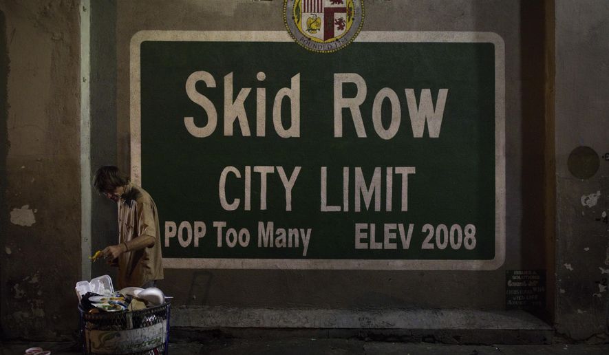 A homeless man takes food from a trash can in Los Angeles&#39; Skid Row area, home to the nation&#39;s largest concentration of homeless people, Saturday, Oct. 28, 2017, in Los Angeles. (AP Photo/Jae C. Hong)