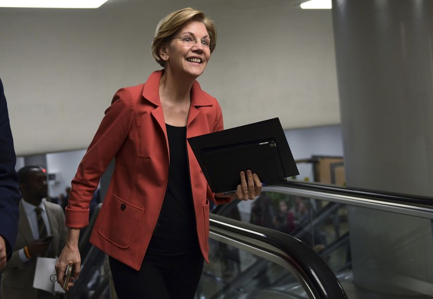 Sen. Elizabeth Warren, D-Mass., walks to vote on Capitol Hill in Washington, Tuesday, Nov. 7, 2017. (AP Photo/Susan Walsh)
