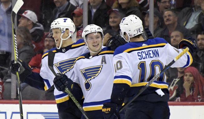 St. Louis Blues right wing Vladimir Tarasenko, center, celebrates his goal with defenseman Carl Gunnarsson, left, and center Brayden Schenn (10) during the second period of an NHL hockey game against the New Jersey Devils on Tuesday, Nov. 7, 2017, in Newark, N.J. (AP Photo/Bill Kostroun