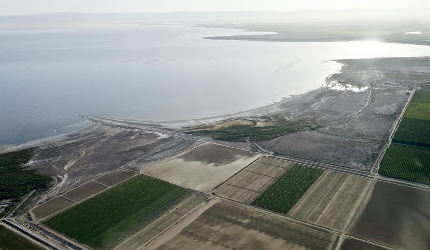 FILE - This May 1, 2015 file photo shows the exposed lake bed of the Salton Sea drying out near Niland, Calif. California regulators Tuesday, Nov. 7, 2017, approved a plan to spend nearly $400 million over 10 years to slow the shrinking of the state's largest lake, a major resting place for migratory birds and a buffer against swirling dust in farming towns. (AP Photo/Gregory Bull, File)