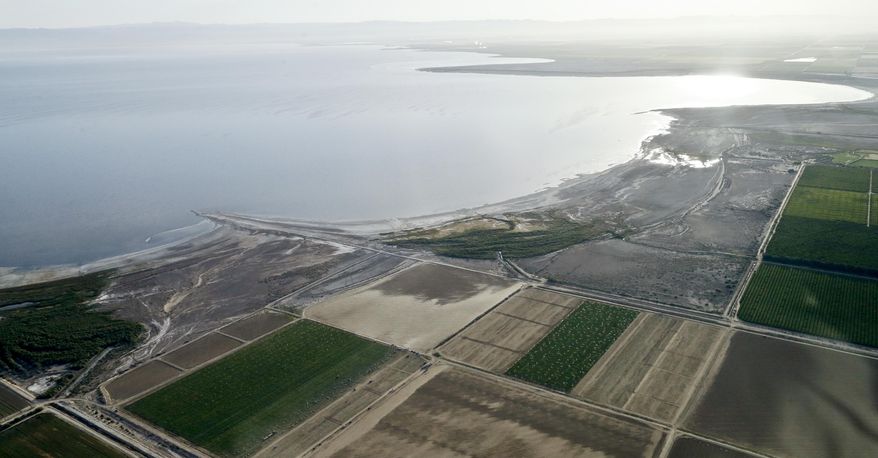 FILE - This May 1, 2015 file photo shows the exposed lake bed of the Salton Sea drying out near Niland, Calif. California regulators Tuesday, Nov. 7, 2017, approved a plan to spend nearly $400 million over 10 years to slow the shrinking of the state's largest lake, a major resting place for migratory birds and a buffer against swirling dust in farming towns. (AP Photo/Gregory Bull, File)