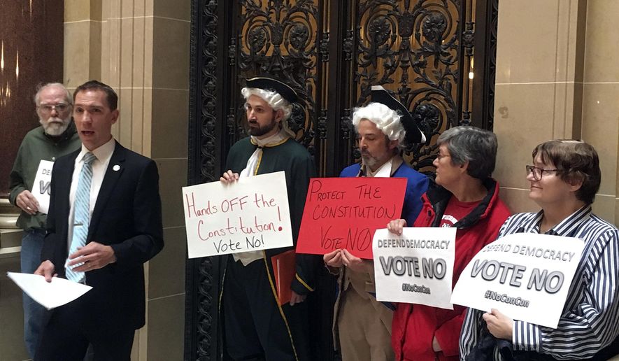 Wisconsin state Sen. Chris Larson leads demonstrators outside the Senate chambers in the state Capitol, Tuesday, Nov. 7, 2017 in Madison, Wisc. They were protesting against a resolution calling for a convention of states to add a balanced budget amendment to the U.S Constitution. (AP Photo/Todd Richmond)