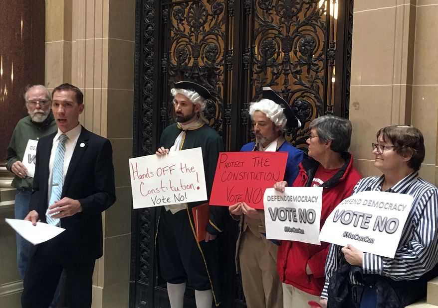 Wisconsin state Sen. Chris Larson leads demonstrators outside the Senate chambers in the state Capitol, Tuesday, Nov. 7, 2017 in Madison, Wisc. They were protesting against a resolution calling for a convention of states to add a balanced budget amendment to the U.S Constitution. (AP Photo/Todd Richmond)
