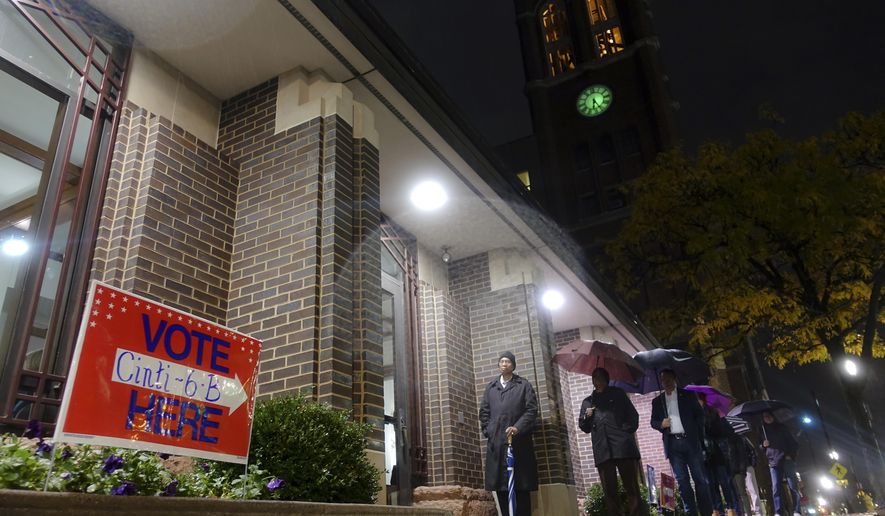 Voters arrive at a polling station, Tuesday, Nov. 7, 2017, in downtown Cincinnati. Ohio voters will decide ballot issues on Tuesday that would place limits on drug prices and expand victims' rights in criminal proceedings, along with several mayoral races. (AP Photo/John Minchillo)
