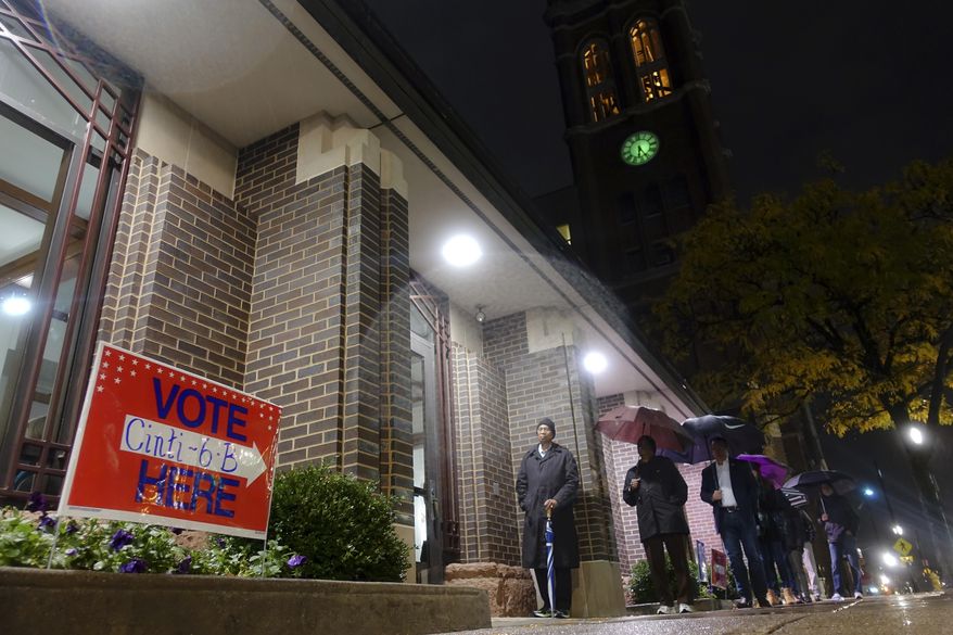 Voters arrive at a polling station, Tuesday, Nov. 7, 2017, in downtown Cincinnati. Ohio voters will decide ballot issues on Tuesday that would place limits on drug prices and expand victims' rights in criminal proceedings, along with several mayoral races. (AP Photo/John Minchillo)