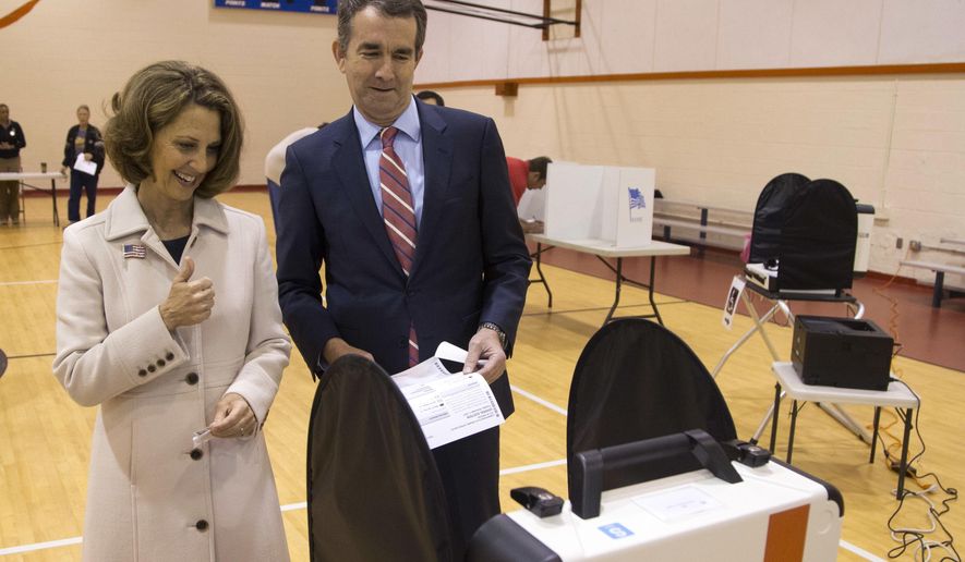 Democratic gubernatorial candidate Lt. Gov. Ralph Northam, and his wife, Pam, approach the vote tally machine as the vote in Norfolk, Va., Tuesday, Nov. 7, 2017. Northam faces Republican Ed Gillespie in today&#x27;s election. (AP Photo/Steve Helber)