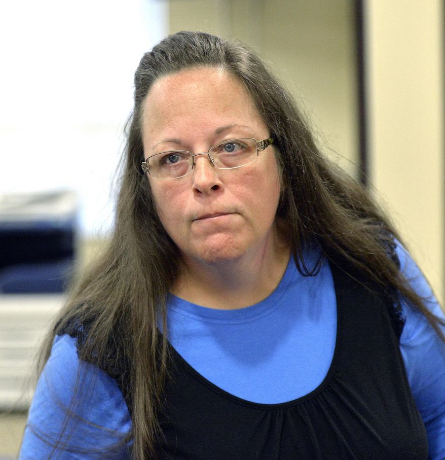 FILE- In this Sept. 1, 2015, file photo, Rowan County Clerk Kim Davis listens to a customer at the Rowan County Courthouse in Morehead, Ky. Davis, who spent five days in jail for refusing to issue marriage licenses to same-sex couples, will run for re-election in 2018, the first chance voters will get to have a say on the controversy that dominated national news. (AP Photo/Timothy D. Easley, File)