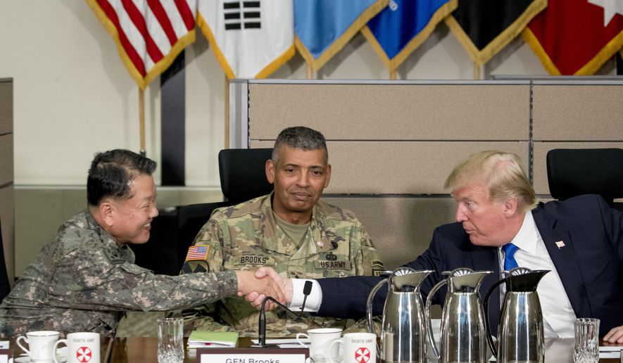 U.S. President Donald Trump, accompanied by United States Forces Korea Commander Gen. Vincent Brooks, center, shakes hands with South Korean Gen. Kim Byung-joo during an operational briefing at the eighth Army Operational Command Center at Camp Humphreys in Pyeongtaek, South Korea, Tuesday, Nov. 7, 2017. Trump is on a five-country trip through Asia traveling to Japan, South Korea, China, Vietnam and the Philippines. (AP Photo/Andrew Harnik) ** FILE **