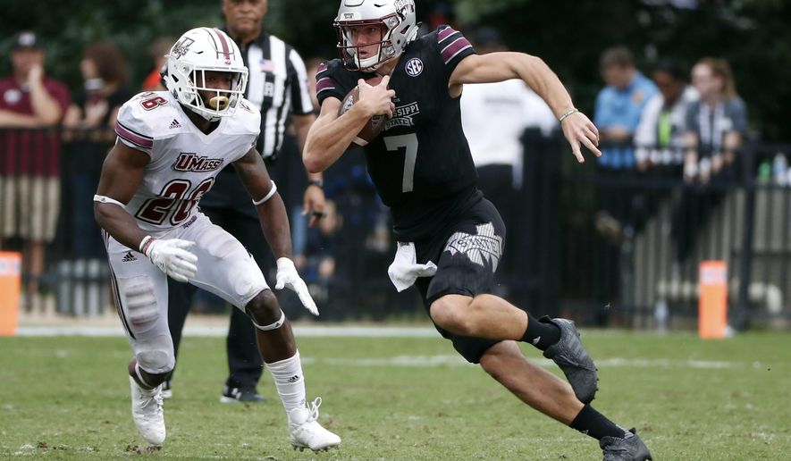 Mississippi State quarterback Nick Fitzgerald (7) runs for a first down past Massachusetts linebacker Jarell Addo (26) in the second half of an NCAA college football game against in Starkville, Miss., Saturday, Nov. 4, 2017. No. 21 Mississippi State won 34-23. (AP Photo/Rogelio V. Solis)