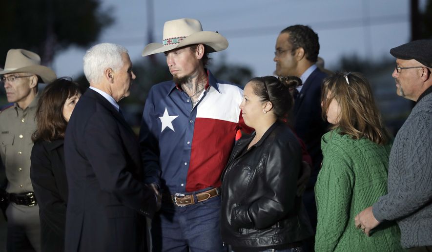 Vice President Mike Pence and his wife, Karen, talks with Johnnie Langendorff, and his girlfriend Summer Caddell, third from right, as they visit with first responders, family, friends and victims outside the Sutherland Spring Baptist Church Wednesday, Nov. 8, 2017, in Sutherland Springs, Texas. A man opened fire inside the church in the small South Texas community on Sunday, killing and wounding many. Pastor Frank Pomeroy and his wife Sherri are at right. (AP Photo/Eric Gay)