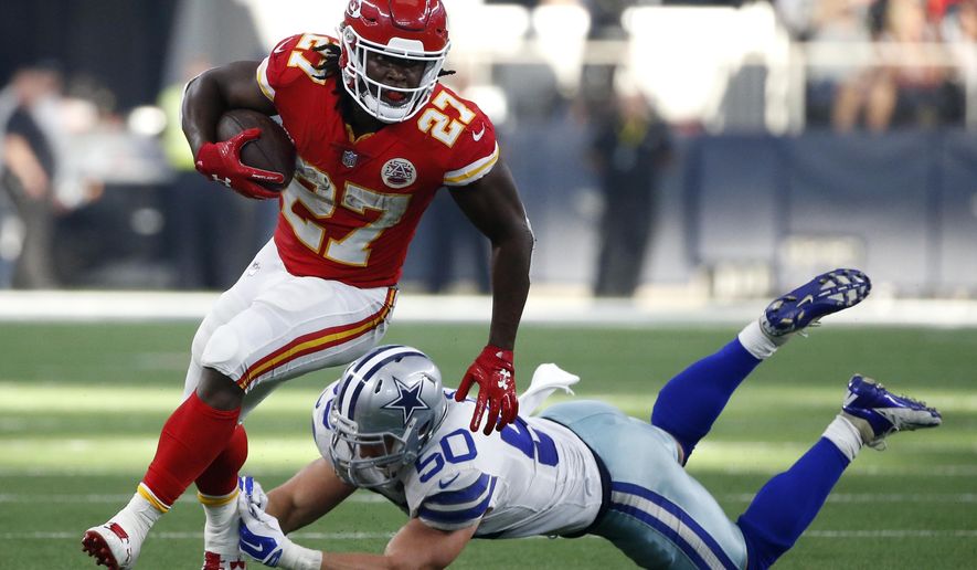 Kansas City Chiefs running back Kareem Hunt (27) escapes a tackle attempt by Dallas Cowboys linebacker Sean Lee (50) in the first half of an NFL football game, Sunday, Nov. 5, 2017, in Arlington, Texas. (AP Photo/Michael Ainsworth)