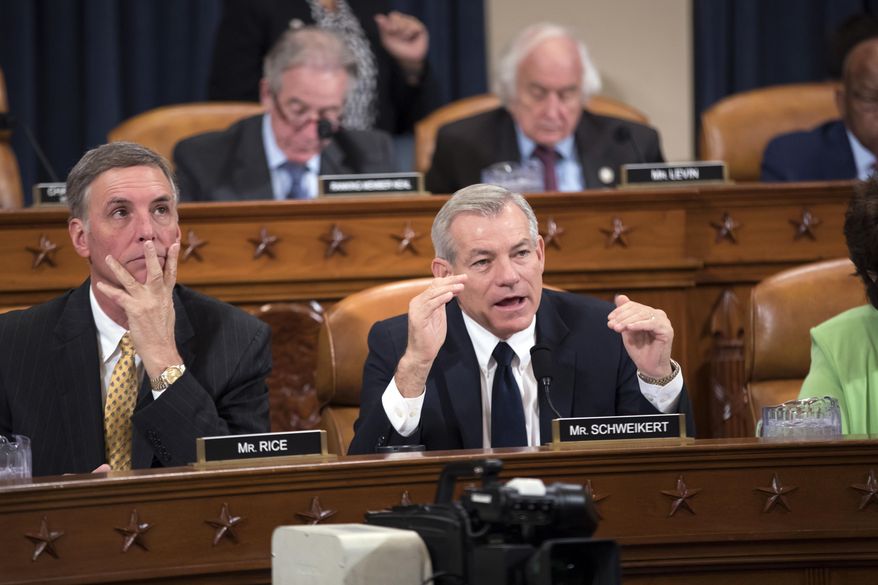 Rep. David Schweikert, R-Ariz., joined at left by Rep. Tom Rice, R-S.C., makes a point as the House Ways and Means Committee continues its debate over the Republican tax reform package, on Capitol Hill in Washington, Wednesday, Nov. 8, 2017. (AP Photo/J. Scott Applewhite)