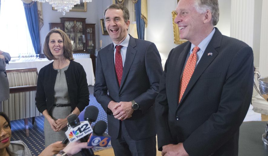 Virginia Gov. Terry McAuliffe, right, shares a laugh with Gov.-elect, Ralph Northam, center, as Pam Northam, left, looks on during a news conference in the Governors mansion at the Capitol in Richmond, Va., Wednesday, Nov. 8, 2017. (AP Photo/Steve Helber)