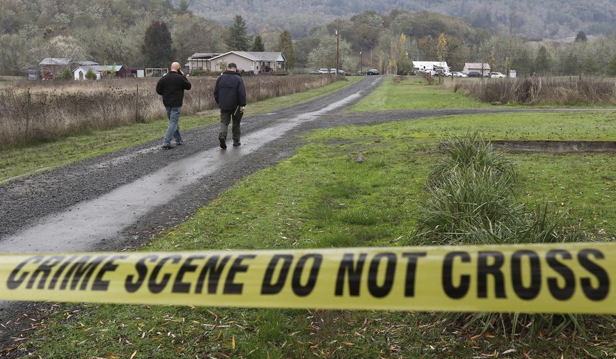 Investigators work at the scene of an alleged homicide, Wednesday Nov. 8, 2017 in Lookingglass, Ore. Authorities arrested a 16-year-old boy accused of fatally shooting three people in southwest Oregon. (Michael Sullivan/The News-Review via AP)