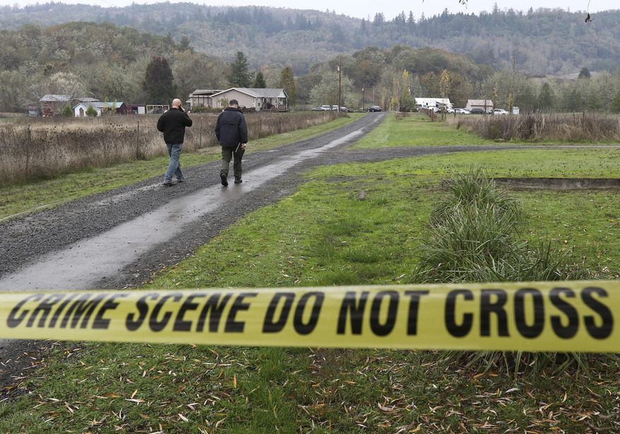 Investigators work at the scene of an alleged homicide, Wednesday Nov. 8, 2017 in Lookingglass, Ore. Authorities arrested a 16-year-old boy accused of fatally shooting three people in southwest Oregon. (Michael Sullivan/The News-Review via AP)