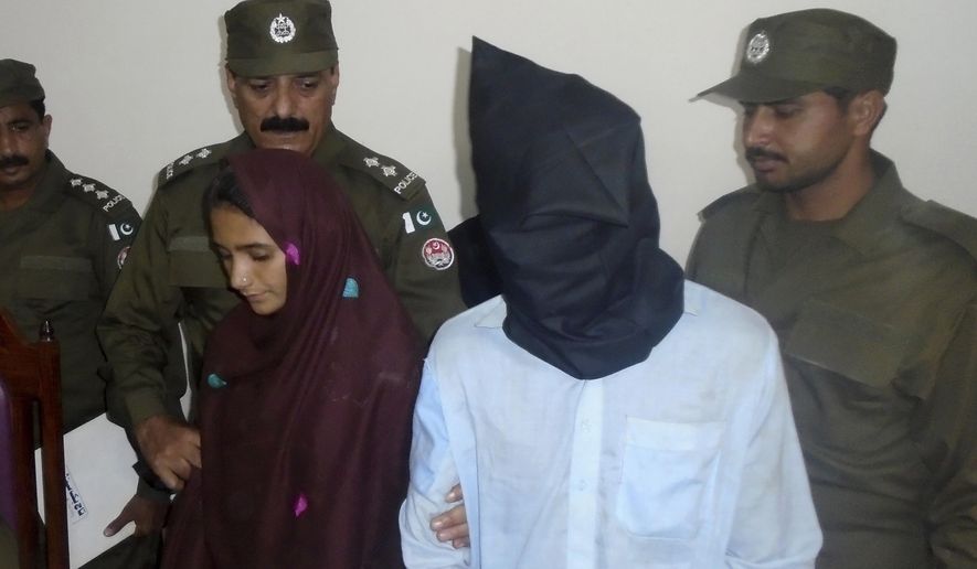 In this Monday, Oct. 30, 2017 photo, 21-year-old Aasia Bibi and her boyfriend, Shahid Lashari, are presented to journalists, at police station in Muzaffargarh in Pakistan. Pakistani police arrested Bibi, a newly married woman, who was married against her will in September, on murder charges after she allegedly poisoned her husband's milk and it inadvertently killed 17 other people in a remote village. (AP Photo/Iram Asim)