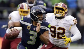 FILE - In this Sunday, Nov. 5, 2017, file photo, Seattle Seahawks quarterback Russell Wilson (3) scrambles away from Washington Redskins defensive end Stacy McGee (92) in the second half of an NFL football game in Seattle. The Seahawks are favored again when they face the Arizona Cardinals on Thursday night. (AP Photo/Stephen Brashear, File) **FILE**