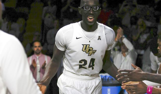 FILE - In this Feb. 26, 2017, file photo, Central Florida center Tacko Fall (24) is introduced before an NCAA college basketball game against Cincinnati, in Orlando, Fla. The tallest player in college basketball strolls the campus at UCF _ not your traditional basketball power. But anybody in the NBA or college hoops who doesn&#x27;t know 7-foot-6 Tacko Fall should get up to speed on the 21-year-old from Senegal.  (AP Photo/Reinhold Matay, File)