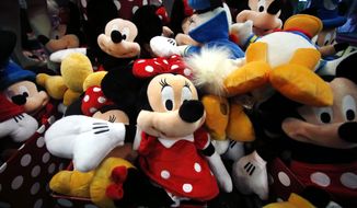 FILE - This Jan. 31, 2014, file photo shows plush Disney characters piled up in a display at a Disney Store in Saugus, Mass. The Walt Disney Co. reports financial results on Thursday, Nov. 9, 2017. (AP Photo/Elise Amendola, File)