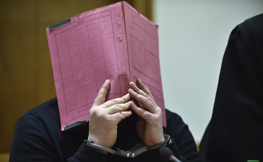 FILE - The Jan. 22, 2015 file photo shows former nurse Niels Hoegel covering his face during his trial at the regional court in in Oldenburg, northern Germany. The prosecutors in Oldenburg on Thursday, Nov. 9, 2017 said that he might have killed more than 100 people based on a toxicologic investigation. (Carmen Jaspersen/dpa via AP)
