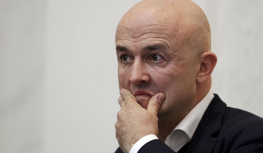Journalist Gianluigi Nuzzi listens to reporter's questions during a press conference to present his latest book "Peccato Originale" (Original Sin), in Rome, Thursday, Nov. 9, 2017. (AP Photo/Andrew Medichini)