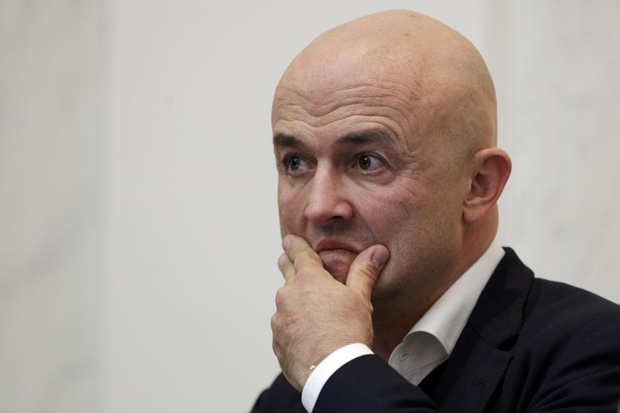 Journalist Gianluigi Nuzzi listens to reporter's questions during a press conference to present his latest book "Peccato Originale" (Original Sin), in Rome, Thursday, Nov. 9, 2017. (AP Photo/Andrew Medichini)