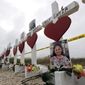Crosses showing shooting victims names stand near the First Baptist Church on Thursday, Nov. 9, 2017, in Sutherland Springs, Texas. A man opened fire inside the church in the small South Texas community on Sunday, killing more than two dozen and injuring others. (AP Photo/David J. Phillip)