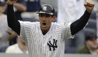 FILE - In this May 23, 2009, file photo, New York Yankees third base coach Rob Thompson celebrates as the Yankees score against the Philadelphia Phillies during the ninth inning of a baseball game in New York. Thomson, a bench coach on the Joe Girardi’s staff for the past decade, is the first candidate to be interviewed to replace the New York Yankees manager, (AP Photo/Frank Franklin II, File)