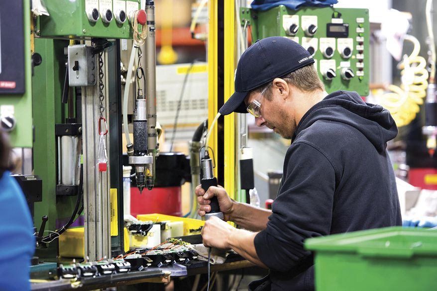 In this Oct. 30, 2017 photo, Wahl Clipper assemblers work on the assembly line that manufactures the companies signature clipper in Sterling, Ill. Wahl Clipper has more than 1,000 workers in Sterling, and it attributes about 100 jobs to its longtime partnership with Walmart. While navigating turbulent economic cycles, Wahl Clipper hasn't laid off a worker in about 50 years, a source of great pride for CEO and President Greg Wahl. (Alex T. Paschal/Sauk Valley Media via AP)