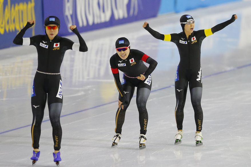 Japan's Miho Takagi, Ayana Sato, and Nana Takagi, from left, celebrate setting a new world record during the women's team pursuit race of the Speedskating World Cup at the Thialf ice rink in Heerenveen, Netherlands, Friday, Nov. 10, 2017. (AP Photo/Peter Dejong)