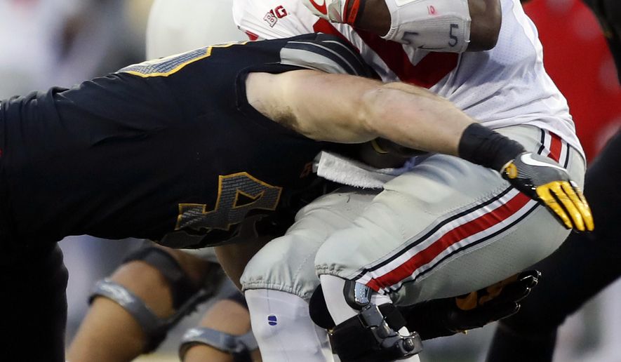 Ohio State quarterback J.T. Barrett is tackled by Iowa linebacker Josey Jewell, left, during the second half of an NCAA college football game, Saturday, Nov. 4, 2017, in Iowa City, Iowa. (AP Photo/Charlie Neibergall)
