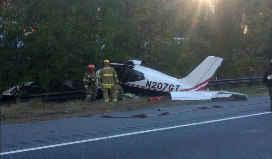 This photo released by the Anne Arundel County Fire Department shows emergency officials responding to a plane crash on Interstate 97 near Annapolis, Md., Friday, Nov. 10, 2017. Fire officials said no one was hurt. (Anne Arundel County Fire Department via AP)
