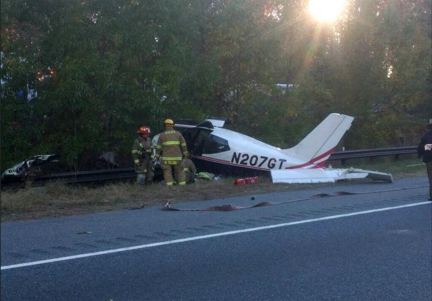 This photo released by the Anne Arundel County Fire Department shows emergency officials responding to a plane crash on Interstate 97 near Annapolis, Md., Friday, Nov. 10, 2017. Fire officials said no one was hurt. (Anne Arundel County Fire Department via AP)