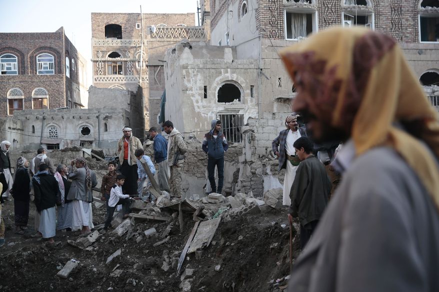 People stand on the rubble of houses at the site of a Saudi-led airstrike near Yemen's Defense Ministry complex in Sanaa, Yemen, Saturday, Nov. 11, 2017. (AP Photo/Hani Mohammed)