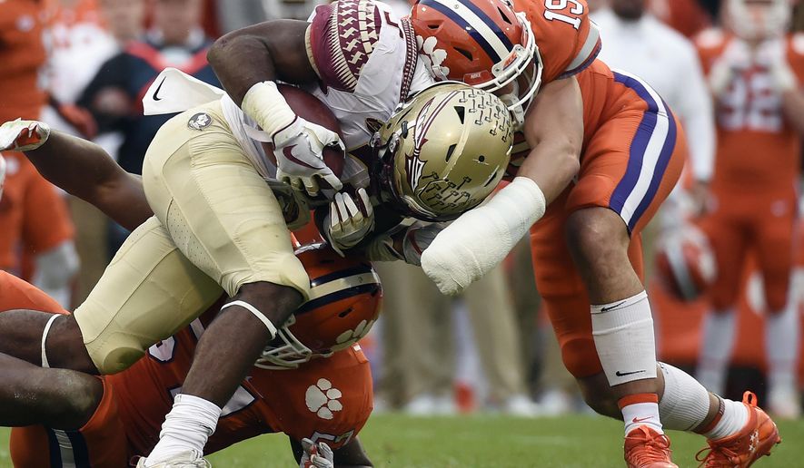 Florida State running back Cam Akers (3) is tackled by Clemson safety Tanner Muse (19) during the first half of an NCAA college football game, Saturday, Nov. 11, 2017, in Clemson, S.C. (AP Photo/Rainier Ehrhardt)