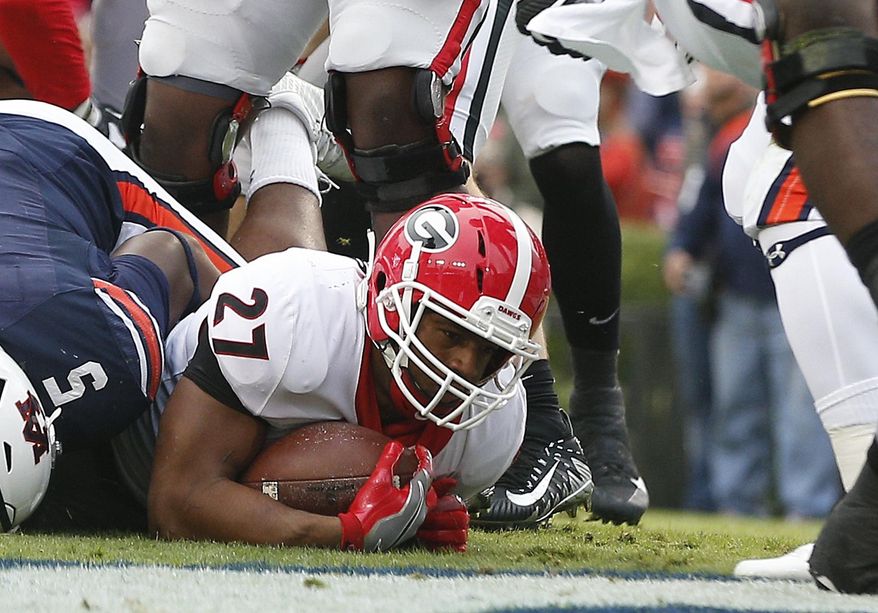 Georgia running back Nick Chubb (27) scores a touchdown against Auburn during the first half of an NCAA college football game on Saturday, Nov. 11, 2017, in Auburn, Ala. (AP Photo/Brynn Anderson)