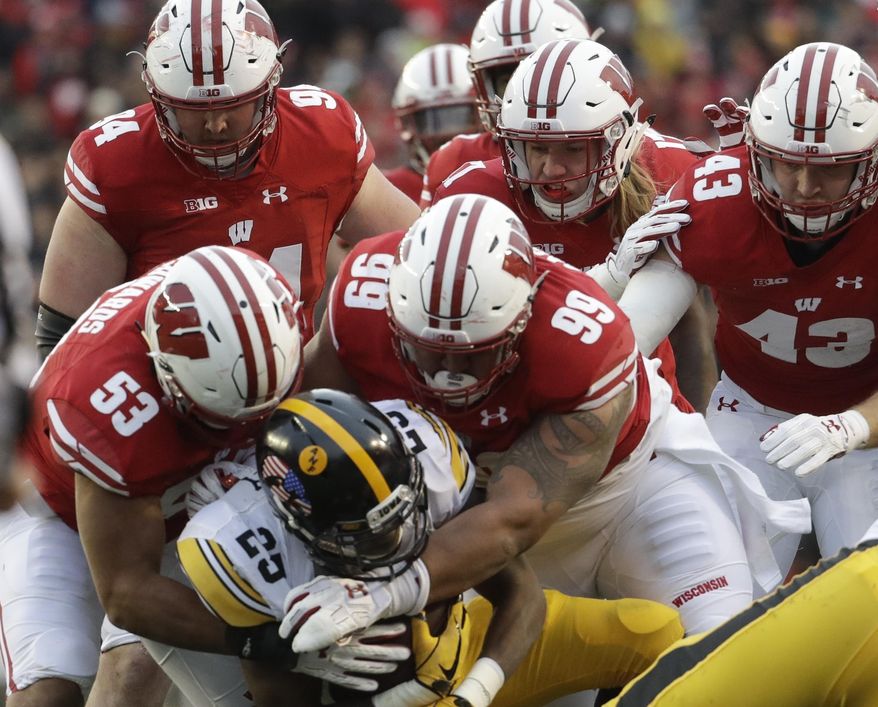 Iowa's Akrum Wadley is stopped during the first half of an NCAA college football game against Wisconsin Saturday, Nov. 11, 2017, in Madison, Wis. (AP Photo/Morry Gash)