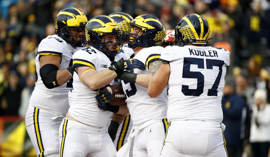 Michigan fullback Henry Poggi, second from right, celebrates his touchdown with teammates in the first half of an NCAA college football game against Maryland in College Park, Md., Saturday, Nov. 11, 2017. (AP Photo/Patrick Semansky)