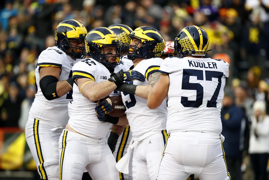 Michigan fullback Henry Poggi, second from right, celebrates his touchdown with teammates in the first half of an NCAA college football game against Maryland in College Park, Md., Saturday, Nov. 11, 2017. (AP Photo/Patrick Semansky)