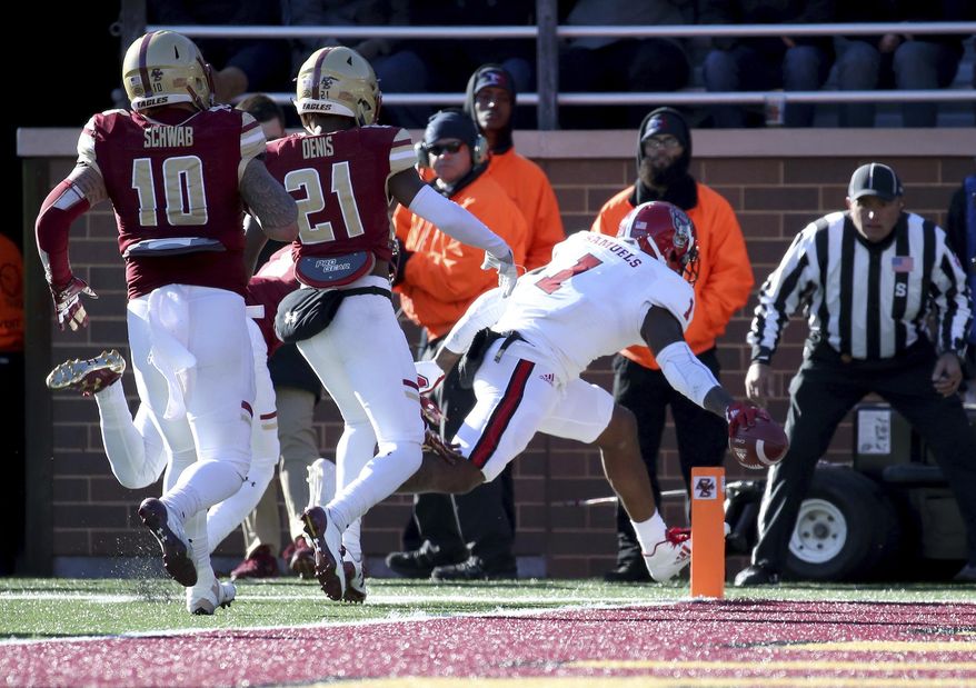 North Carolina State tight end Jaylen Samuels (1) reaches across the pylon for a touchdown ahead of Boston College defenders Ty Schwab (10) and Lukas Denis (21) during the first half of an NCAA college football game Saturday, Nov. 11, 2017, in Boston. (AP Photo/Mary Schwalm)
