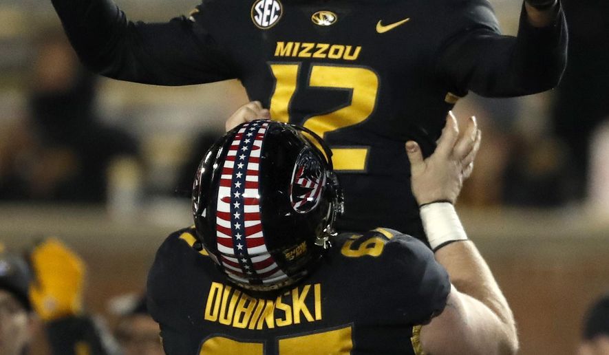 Missouri wide receiver Johnathon Johnson (12) is lifted in celebration by teammate Jonah Dubinski (67) after catching a touchdown pass during the second half of an NCAA college football game against Tennessee, Saturday, Nov. 11, 2017, in Columbia, Mo. (AP Photo/Jeff Roberson)
