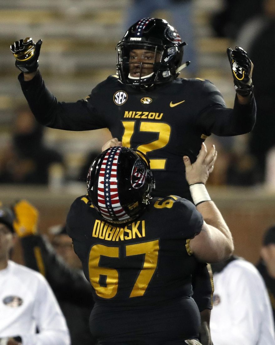 Missouri wide receiver Johnathon Johnson (12) is lifted in celebration by teammate Jonah Dubinski (67) after catching a touchdown pass during the second half of an NCAA college football game against Tennessee, Saturday, Nov. 11, 2017, in Columbia, Mo. (AP Photo/Jeff Roberson)