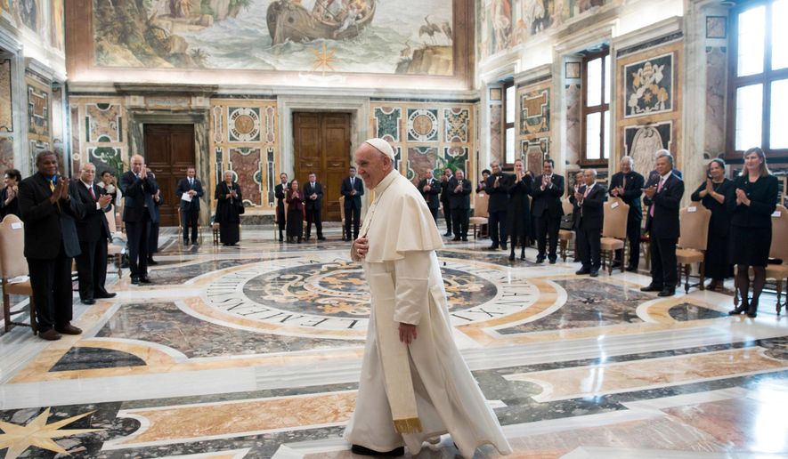Pope Francis walks in the Clementine Hall after meeting with a delegation of Pacific leaders to discuss climate issues, at the Vatican, Saturday, Nov. 11, 2017. Francis met Saturday with a delegation of Pacific leaders and told them he shares their concerns about rising sea levels and increasingly intense storms that are threatening their small islands. (L&#x27;Osservatore Romano/Pool Photo via AP)