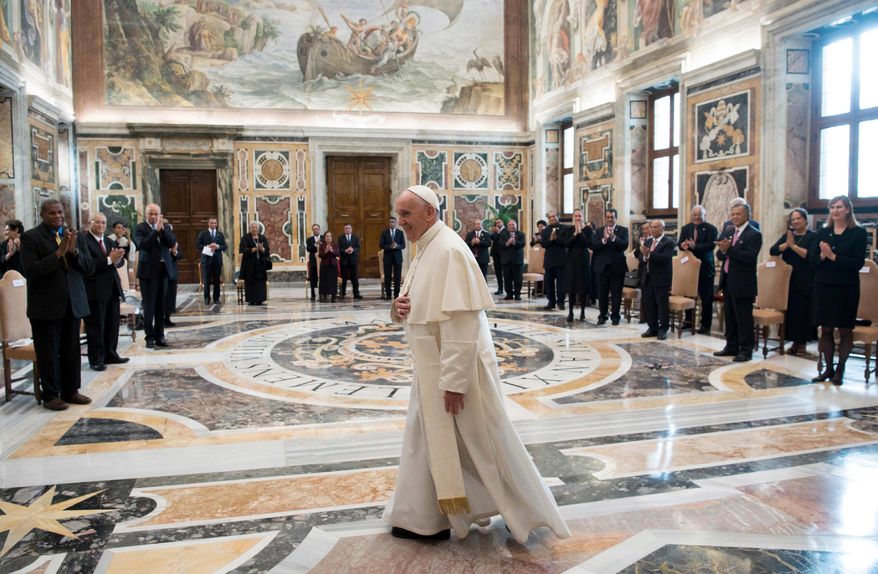 Pope Francis walks in the Clementine Hall after meeting with a delegation of Pacific leaders to discuss climate issues, at the Vatican, Saturday, Nov. 11, 2017. Francis met Saturday with a delegation of Pacific leaders and told them he shares their concerns about rising sea levels and increasingly intense storms that are threatening their small islands. (L'Osservatore Romano/Pool Photo via AP)