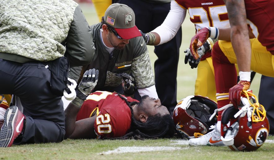 Trainers tend to Washington Redskins running back Rob Kelley (20) after an injury during the first half of an NFL football game against the Minnesota Vikings in Landover, Md., Sunday, Nov. 12, 2017. (AP Photo/Patrick Semansky)
