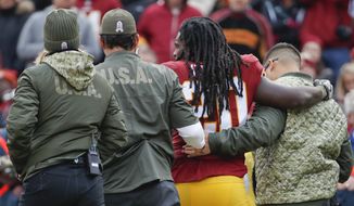 Washington Redskins running back Rob Kelley (20) is helped off the field after an injury during the first half of an NFL football game against the Minnesota Vikings in Landover, Md., Sunday, Nov. 12, 2017. (AP Photo/Alex Brandon)