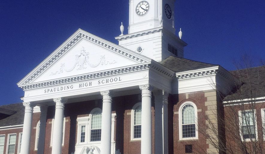 This Sept. 21, 2017 photo provided by David Totty shows tower clock atop Spaulding High School in Rochester, N.H. After it quit working during the summer, Paul Dumont, a retired county commissioner with a background in electronics, came to the rescue and restored the tower clock again, nearly 20 years after he first restored it in 1999. (David Totty via AP)